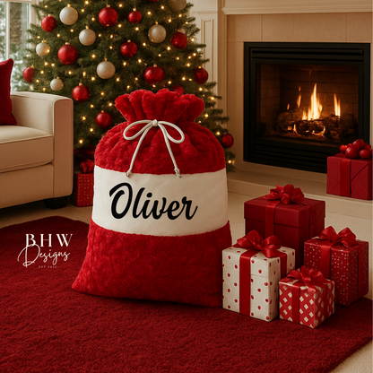 large red and White santa sack personalised with Oliver in black. 