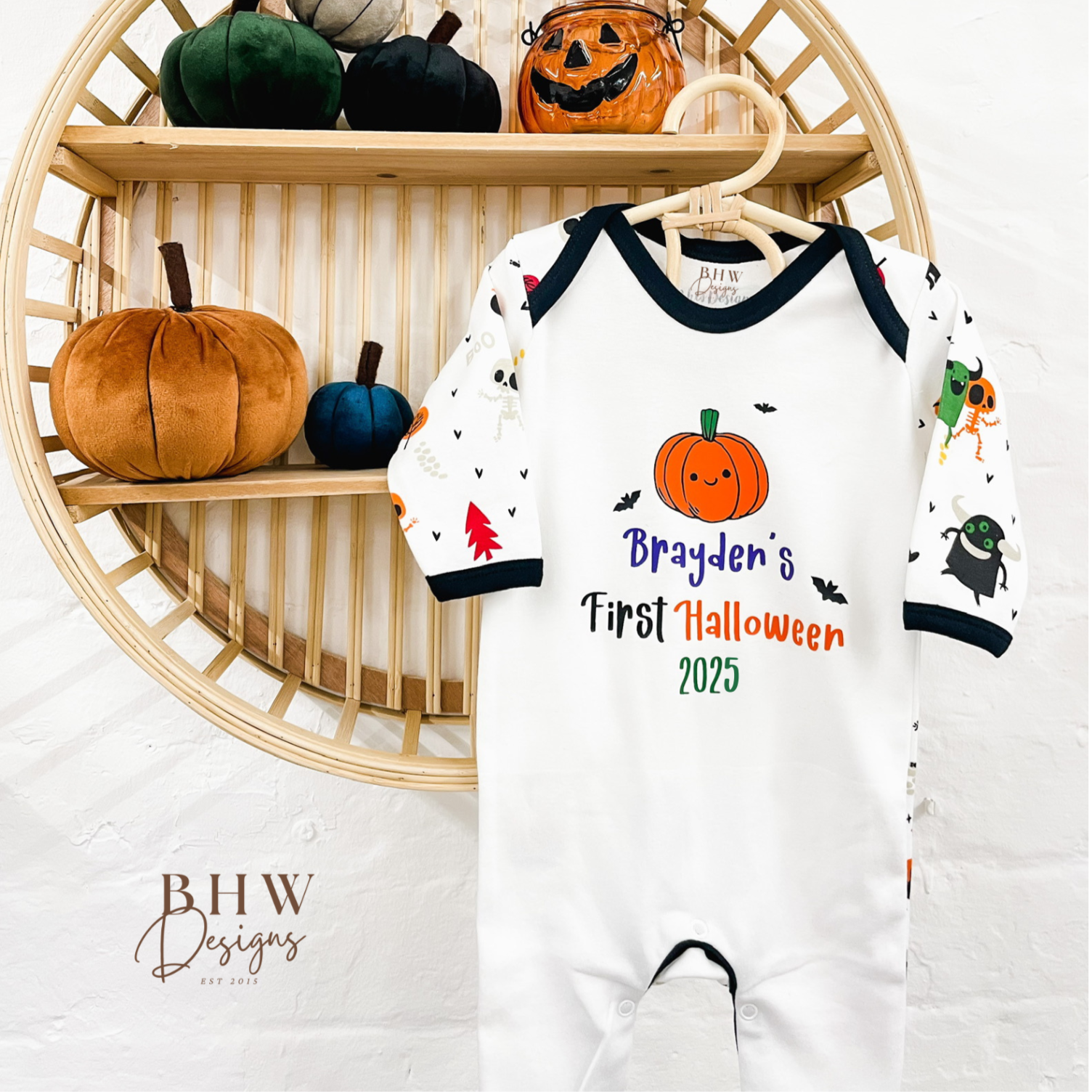 Halloween-themed baby outfit with pumpkins and personalised first halloween 2025 text 