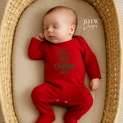 Baby in a red onesie with text, Rileys First Christmas 2025 on the front in Green