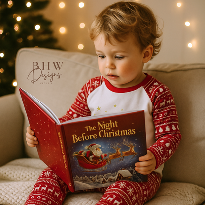 Child in red and white fair isle print  pyjamas reading 'The Night Before Christmas' book on a couch 