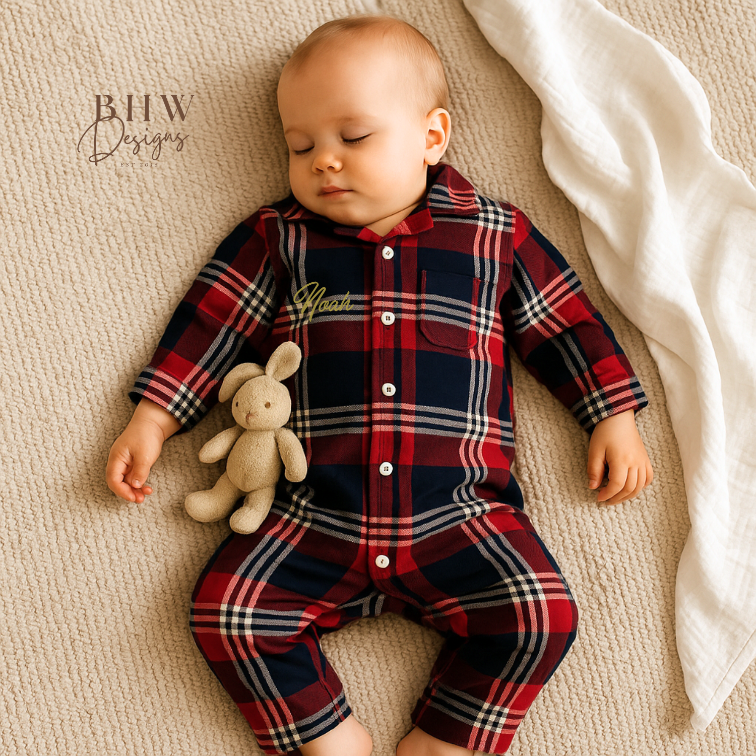 A tartan patterned romper onesie for babies, personalised on the front with a name in script font 