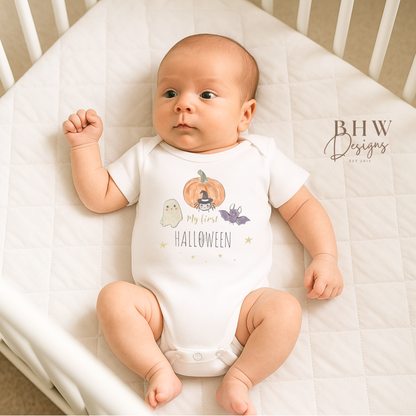 Baby wearing a 'My First Halloween' onesie in a crib