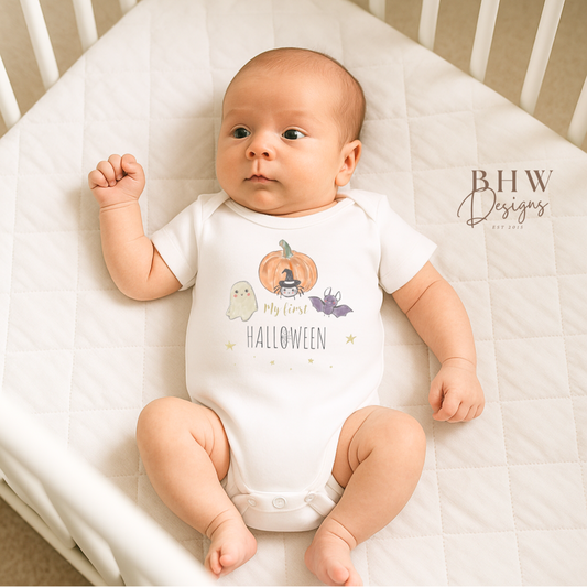Baby wearing a 'My First Halloween' onesie in a crib