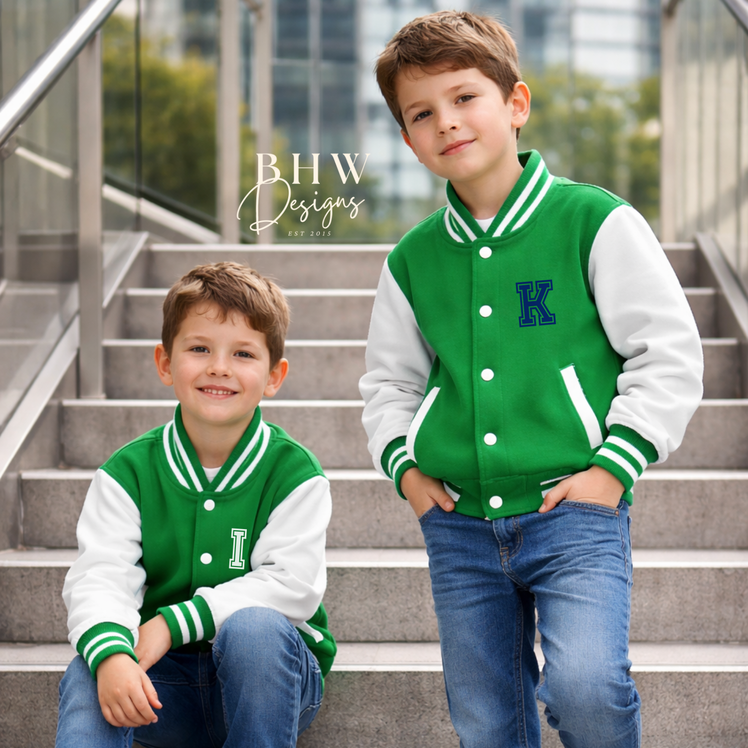 Two boys wearing green and white letterman jackets with a 'K' logo on steps.