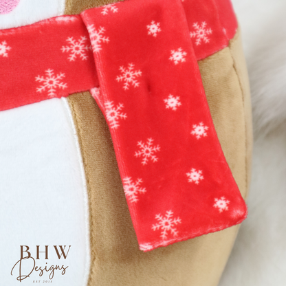 Close-up of a red fabric with snowflake patterns on a brown background, featuring the brand 'BHW Designs'.