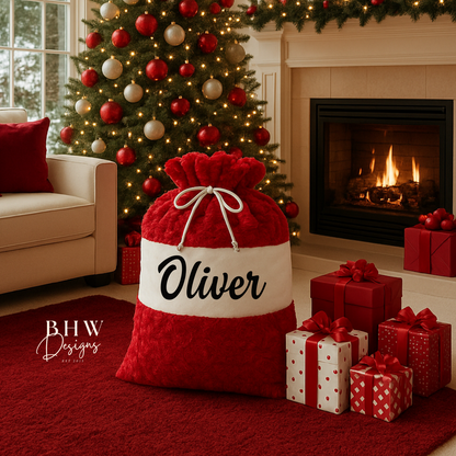 Red and white gift sack with 'Oliver' personalised on it in black 