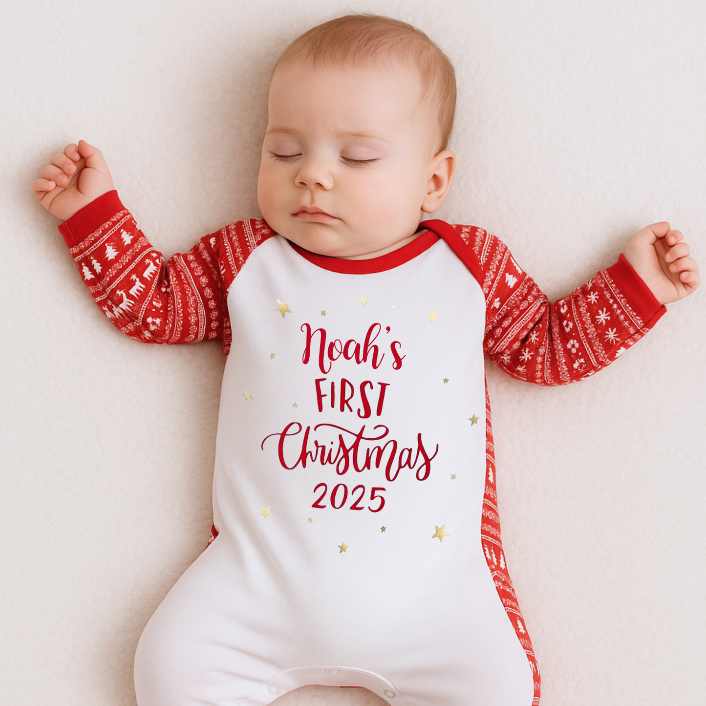 Baby wearing a 'Noah's First Christmas 2025' onesie in a red and white fair isle print