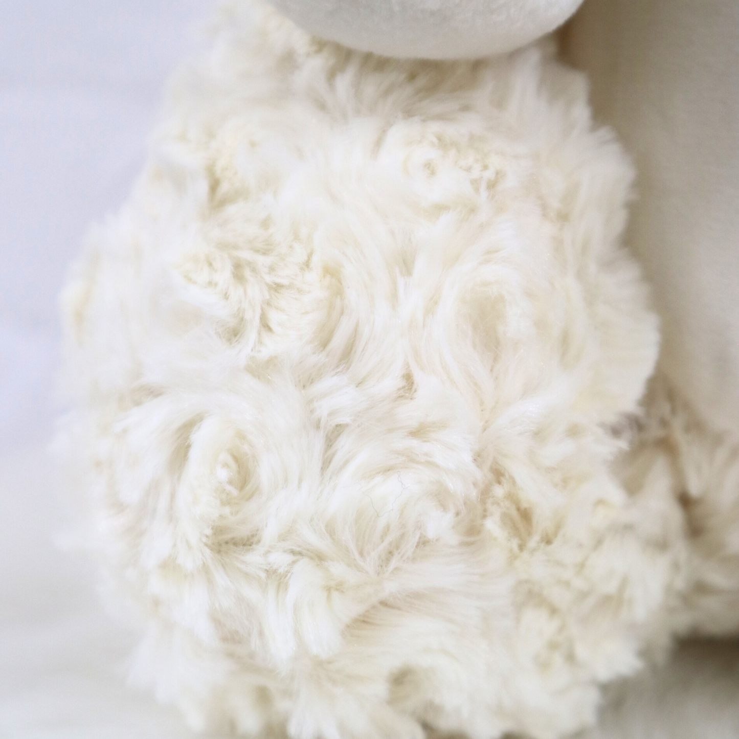 Close-up of a fluffy cream teddy bear