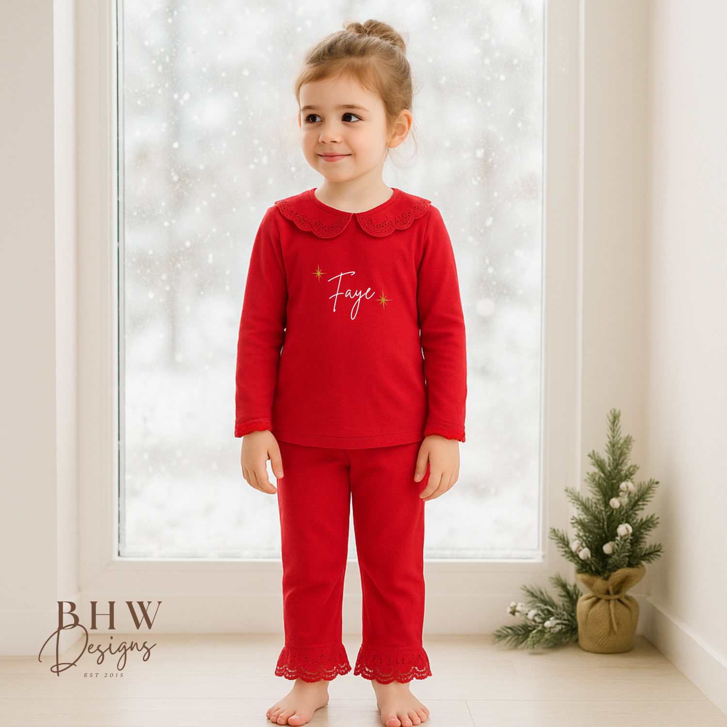Child wearing red pyjamas with lace detail collar personalised n white with gold glitter stars 
