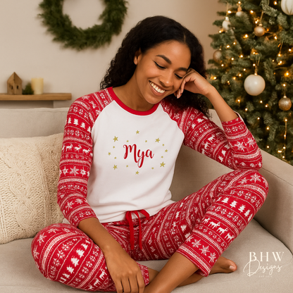 Woman wearing A pair of women's Christmas pyjamas with a red and white Fair Isle print, featuring the word 'May' on the front and adorned with gold stars.