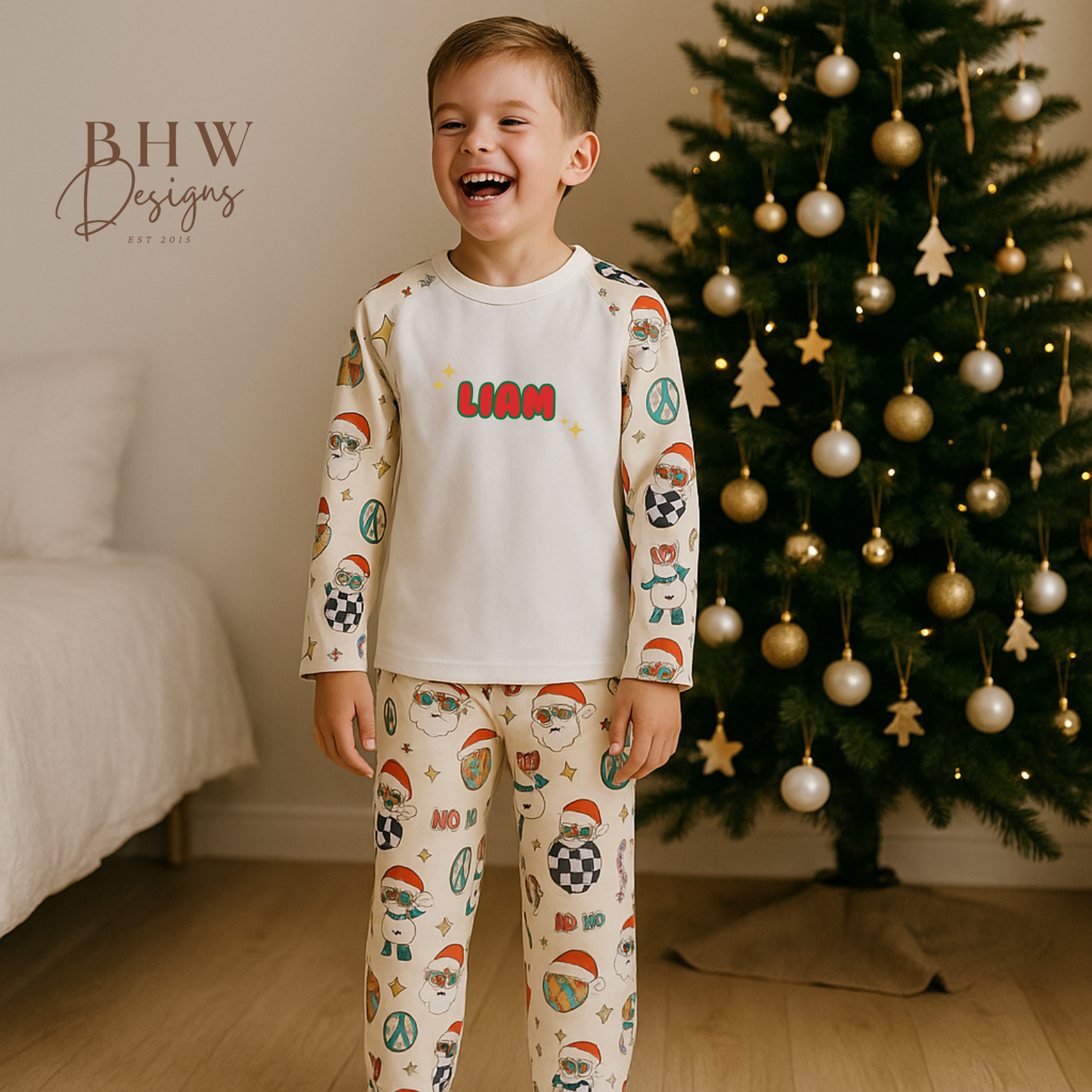 Child wearing a pyjama set with a Christmas print with 'Liam' 