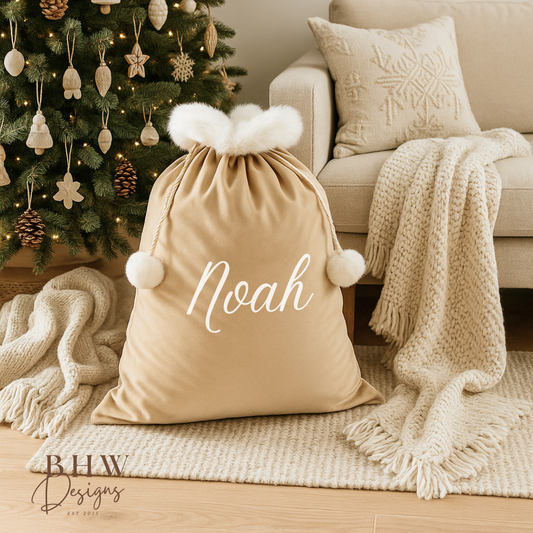 personalised beige velvet Santa sack  it in a cozy living room with a Christmas tree.