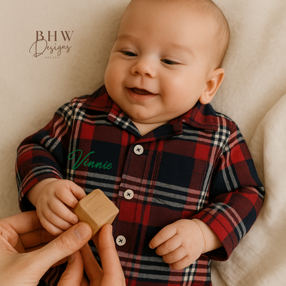 A tartan patterned romper onesie for babies, personalised on the front with a name in script font block.