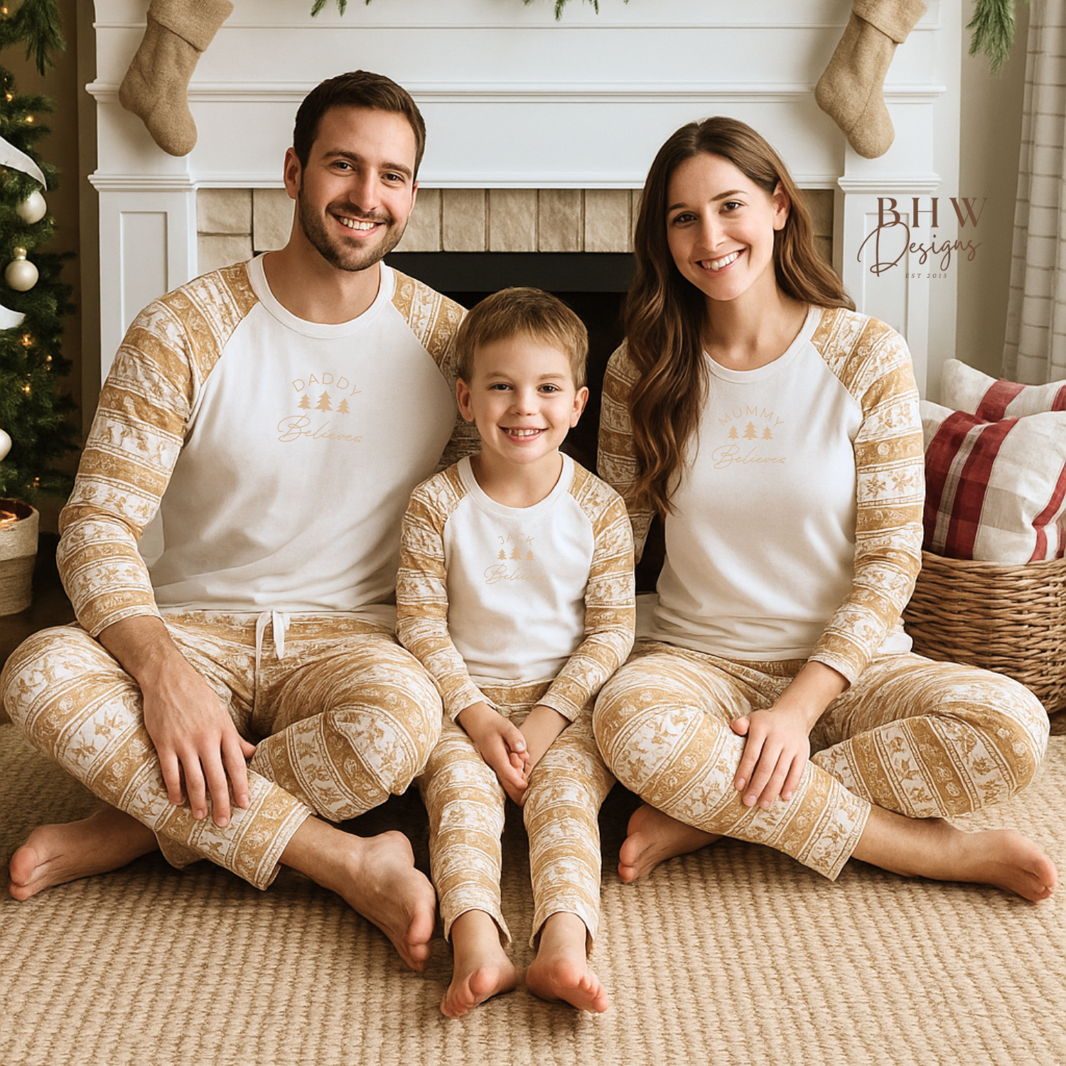 Family of three sitting together in matching pajamas in a cozy living room decorated for Christmas.