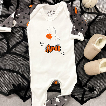 Halloween-themed baby onesie with ghost design and 'Amie' text on a spider web background.