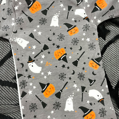 Grey baby onesie with Halloween-themed pattern with pumpkins, ghosts and witches brooms. 