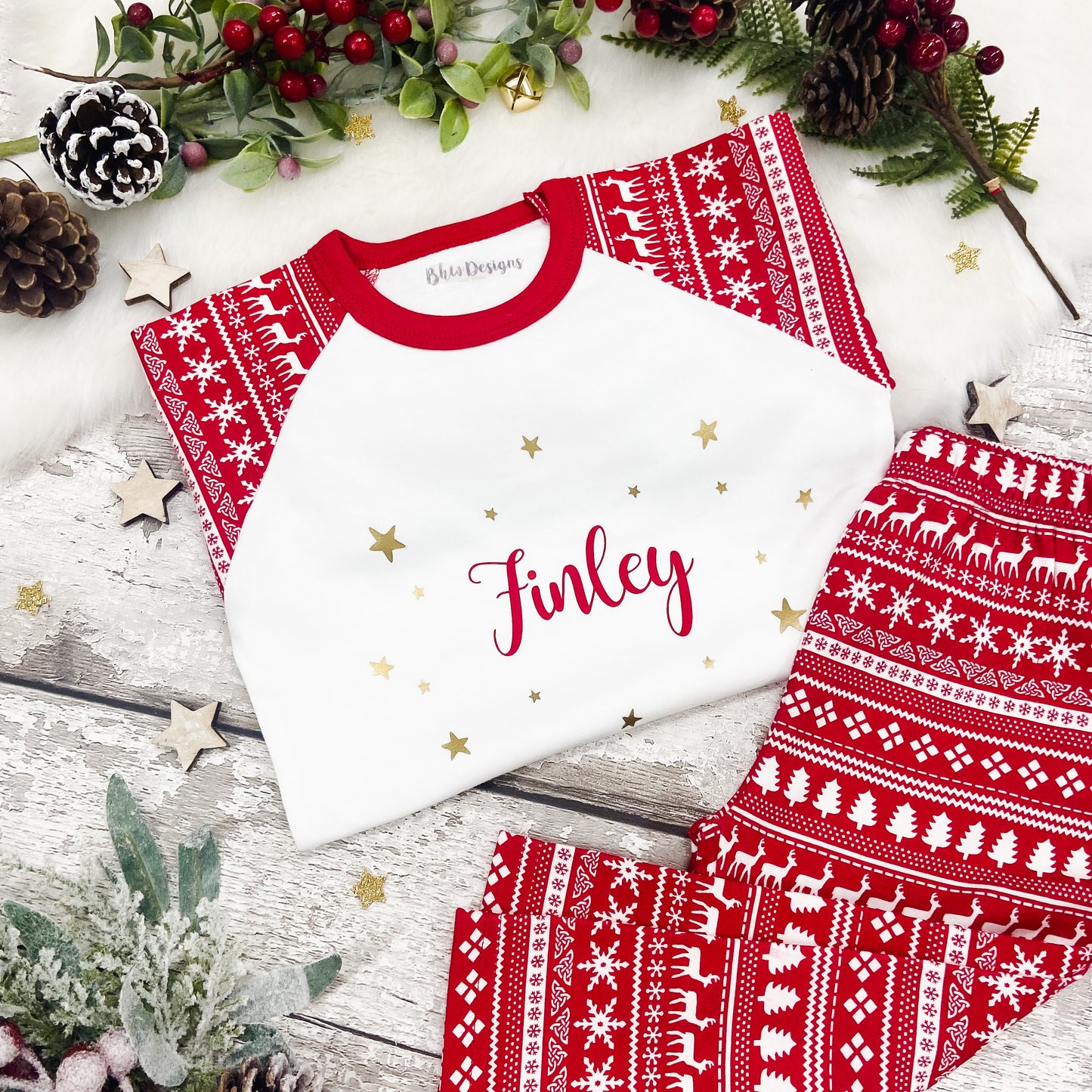 Children's red and white fair isle print patterned top and bottoms personalised in red with gold stars 