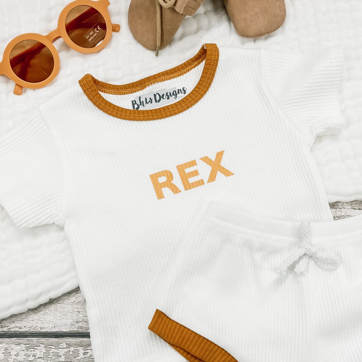 Children's outfit with 'REX' printed on a in mustard