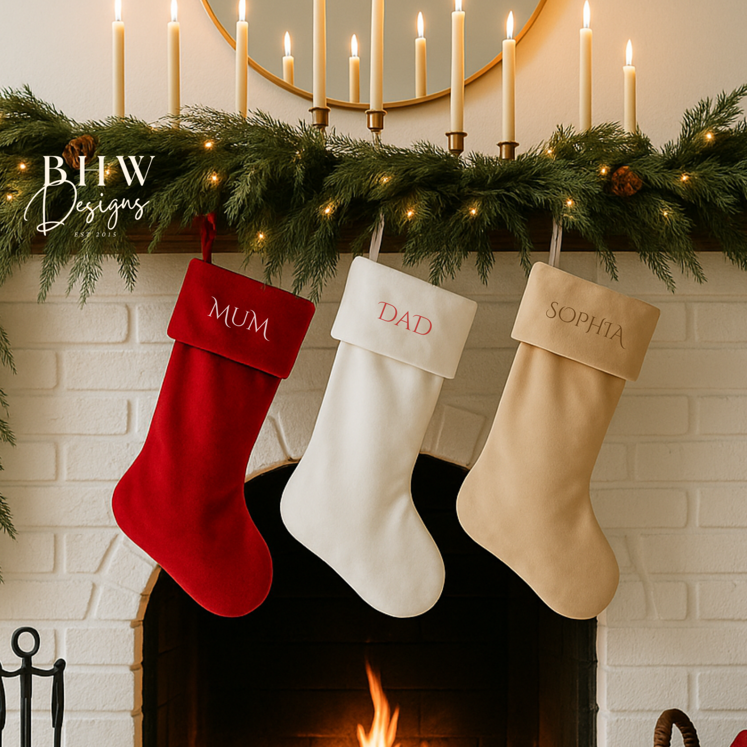 Three Christmas stockings labeled 'MUM', 'DAD', and 'SOPHIA' hanging above a fireplace with candles and greenery.