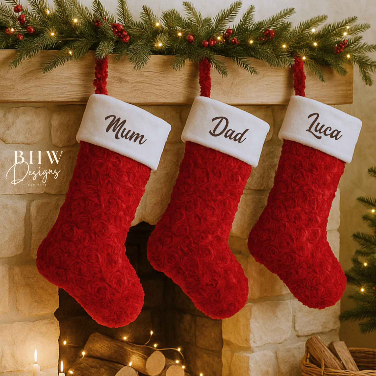 Three red and white Christmas stockings hanging on a fireplace mantel with personalised names.